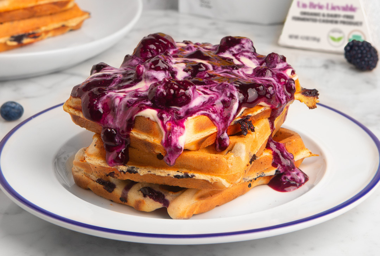 A plate of blueberry waffles with Nuts For Cheese Un-Brie-Lievable Cheese