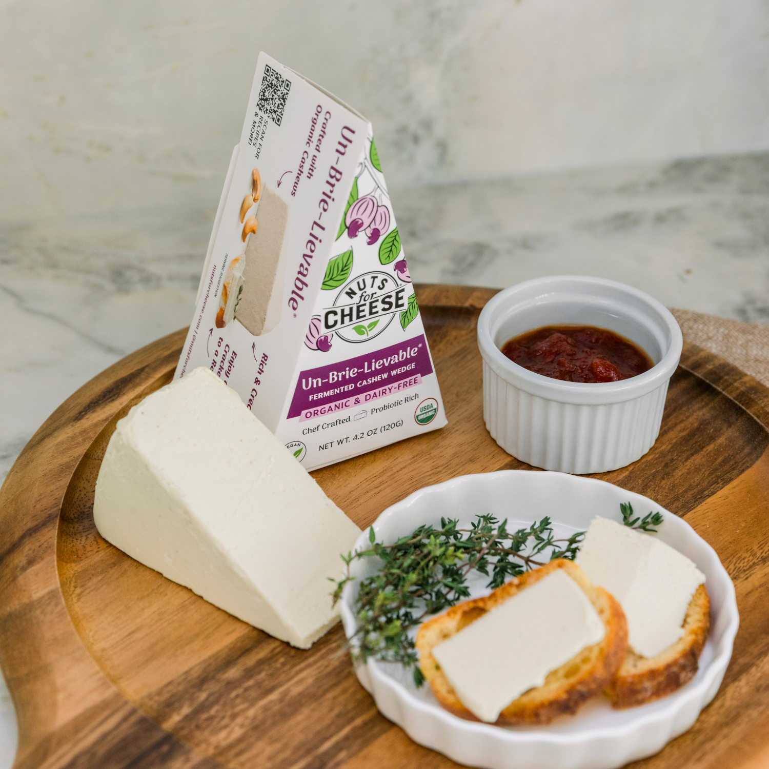 Wedge of Un-Brie-Lievable cheese on a wooden board.
