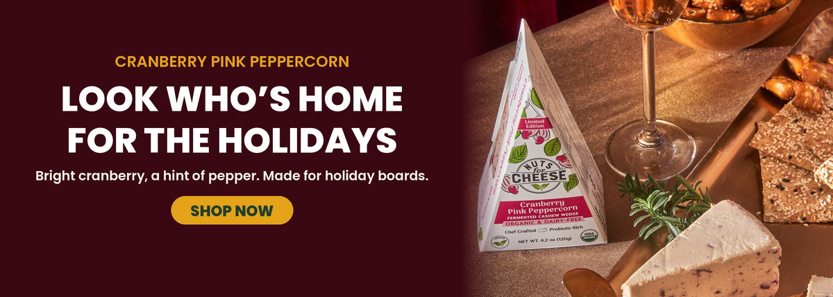 A holiday-themed product banner for Cranberry Pink Peppercorn shown on a cheese board.