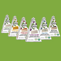 All six Nuts for Cheese organic dairy-free cheese wedge flavours with green background