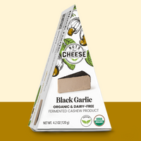 Nuts for Cheese black garlic organic and dairy-free cheese wedge box with gold two toned background