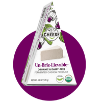 Nuts For Cheese™ Organic & dairy-free fermented Brie cheese wedge package on a purple circle background