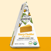 Nuts for Cheese Sharp Cheddar organic and dairy-free cheese wedge box with yellow two toned background