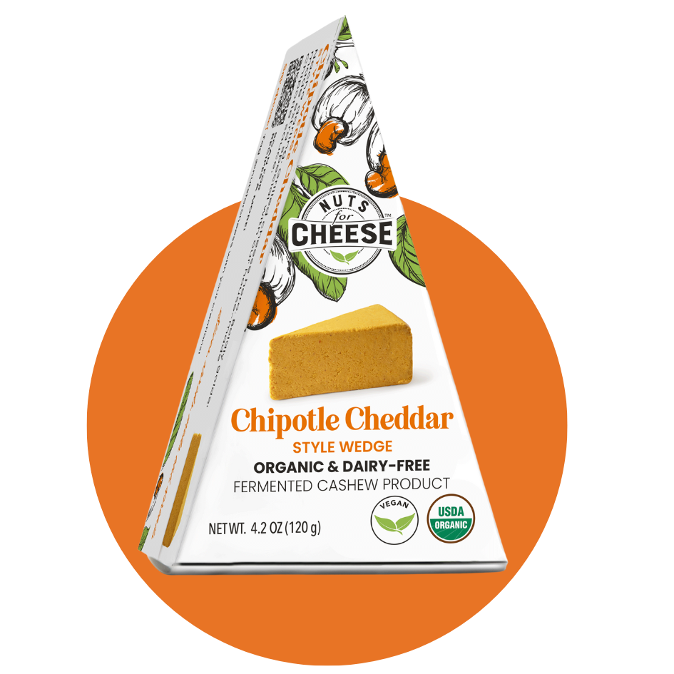 Nuts For Cheese™ Emballage de fromage Cheddar Chipotle fermenté biologique et sans produits laitiers sur un fond de cercle orange