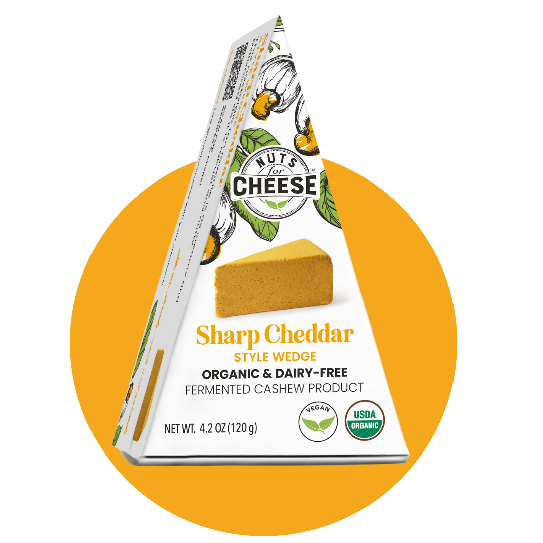 Nuts For Cheese™ Organic & dairy-free fermented Sharp Cheddar cheese wedge package on a yellow circle background