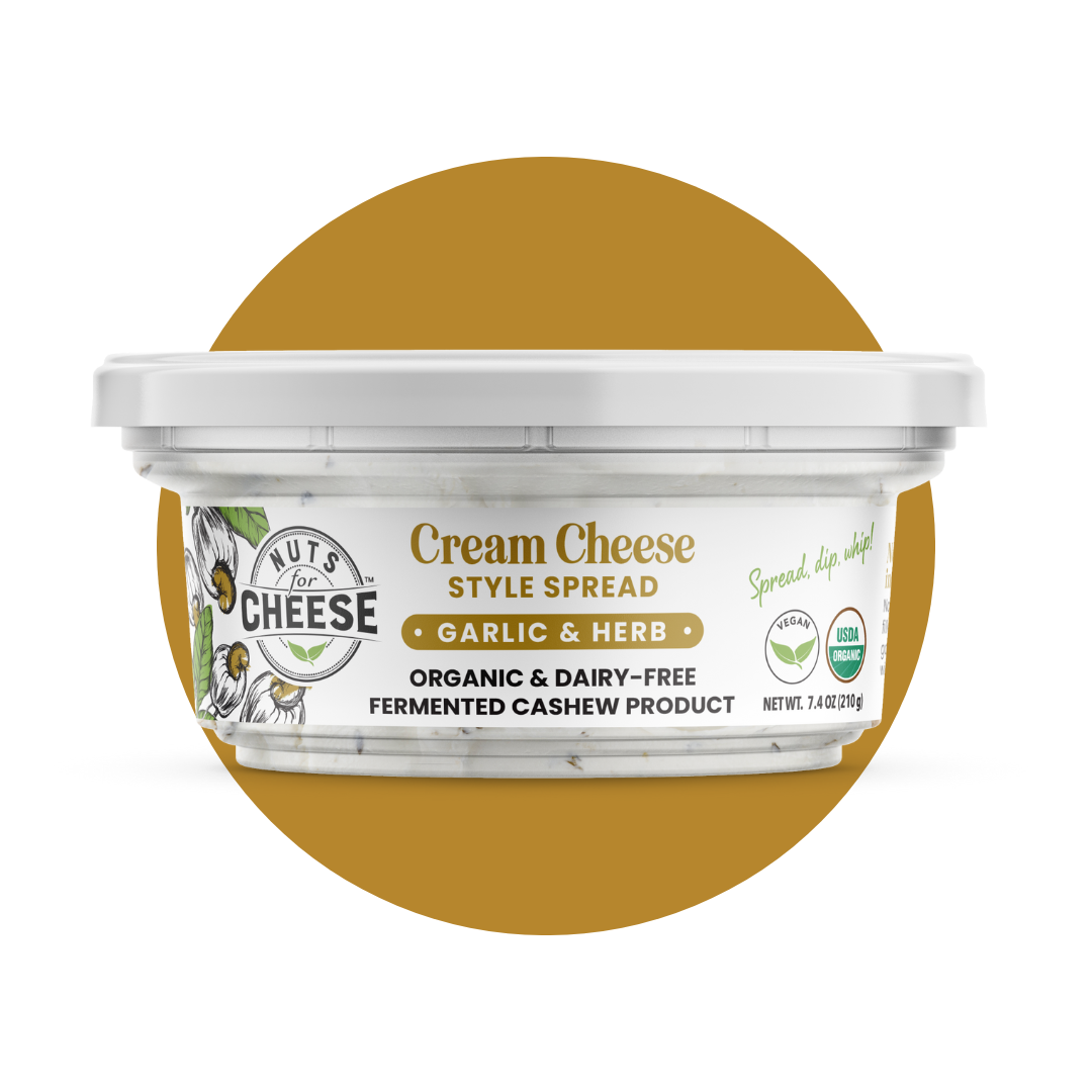 Nuts For Cream Cheese™ Organic & dairy-free fermented Garlic and Herb cream cheese package on a gold circle background